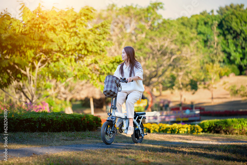 Asian woman riding a bicycle at the park © Sitthipong