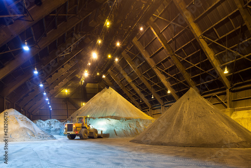 Photography Mechanical shovel arranging copper concentrate stock pile.