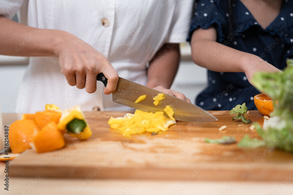 Hand holding knife and cutting paper ring in kitchen at home Hand holding knife and cutting paper ring in kitchen at home