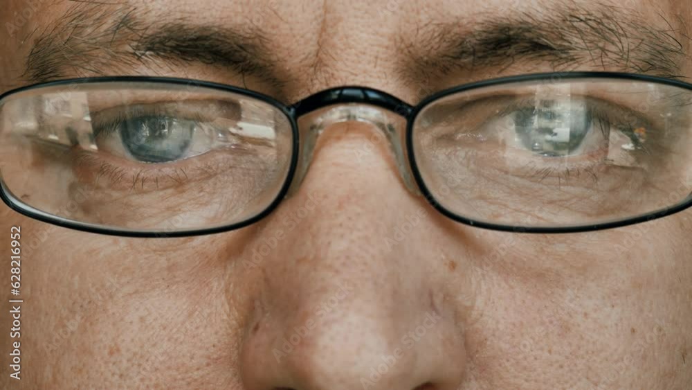 Opening eyes,The face and eyes of a man with glasses. close-up face. portrait of a man with glasses.looks at the camera and closes his eyes. Opening eyes,The face and eyes of a man with glasses. close-up face. portrait of a man with glasses.looks at the camera and closes his eyes.