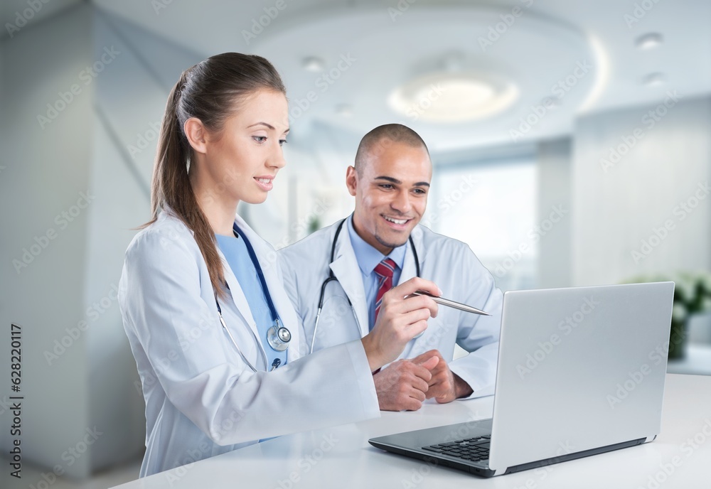 Team of doctors work with laptop in modern hospital, AI generated image Team of doctors work with laptop in modern hospital, AI generated image