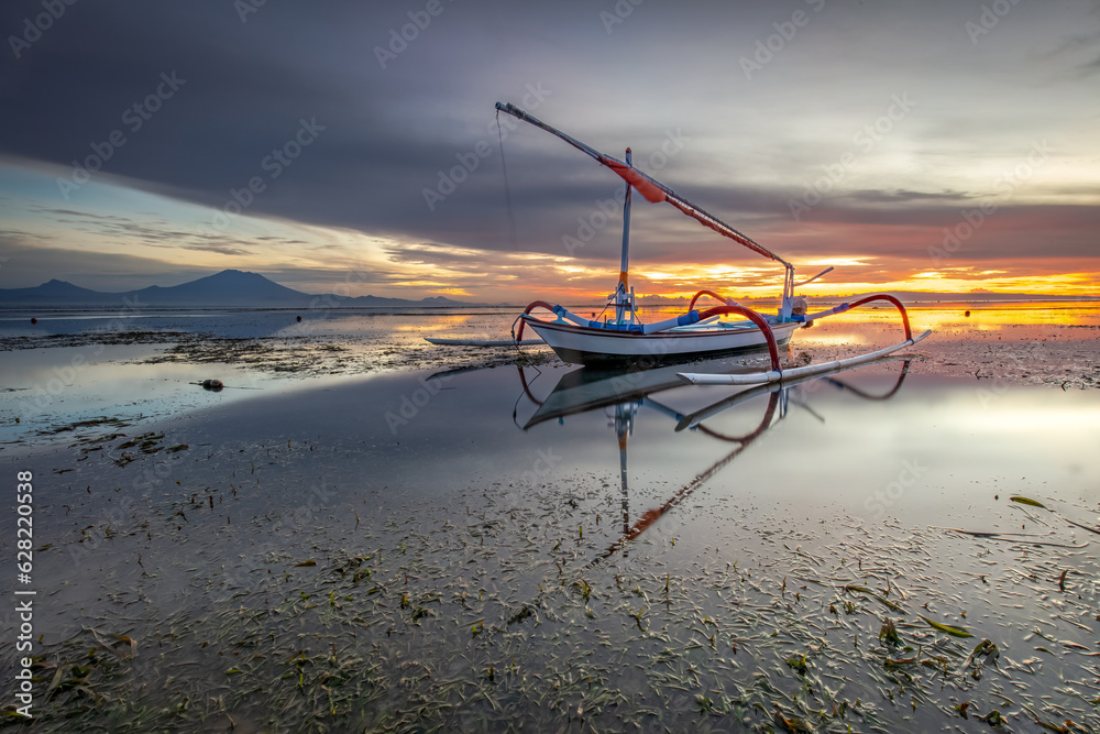 sunrise view and orange sky on the beach with traditional fishing boats sunrise view and orange sky on the beach with traditional fishing boats