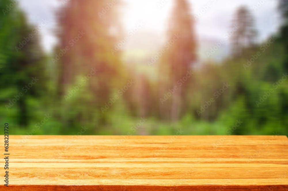 Beautiful blurred forest with empty wooden table Beautiful blurred forest with empty wooden table