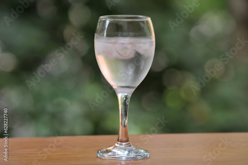 Mineral water in a wineglass with ice