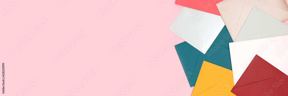 Banner with envelopes scattered on a pink background. Creative concept with copy space. Banner with envelopes scattered on a pink background. Creative concept with copy space.