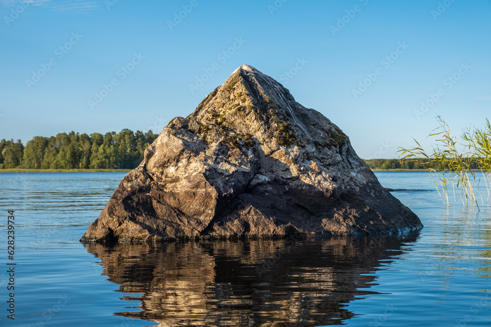 A sharp stone sticks out of the water