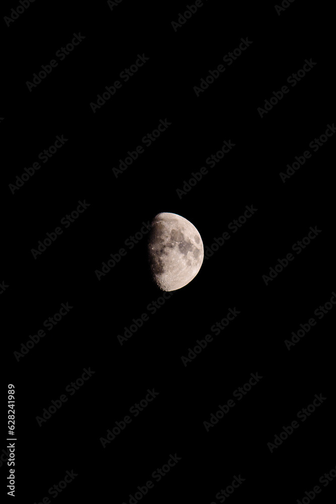 bright half white moon on black background bright half white moon on black background