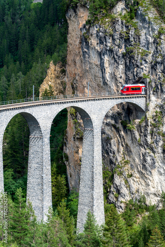 Zug fährt auf dem Landwasserviadukt in Tunnel ein, Graubünden, Schweiz photo