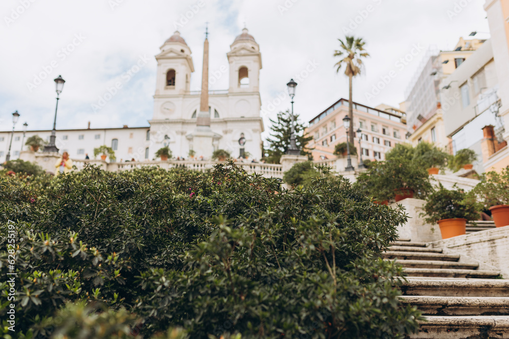 Spanish steps in Rome, Italy. Piazza di Spagna square, Trinita dei Monti Church. Concept of traveling famous landmarks. Selective focus