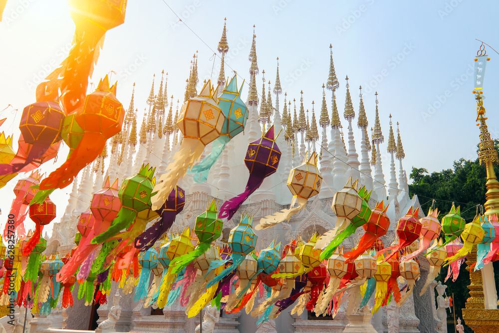 Fototapeta premium Thai temple (WatThai) is decorating the lamp before the start Songkran Festival. This culture celebrated in a traditional New Year's Day.People Watering on Buddha statue and make merit with the monks