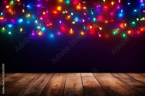 Empty table and Christmas lights string on blue background with copy space