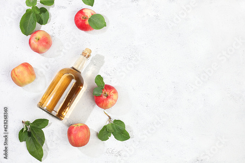 Fototapeta Naklejka Na Ścianę i Meble -  Apple cider drink, juice or fermented fruit drink and ingredients on a sunny table. Autumn banner. The concept of diet and weight loss. Healthy eating, body detoxification, 