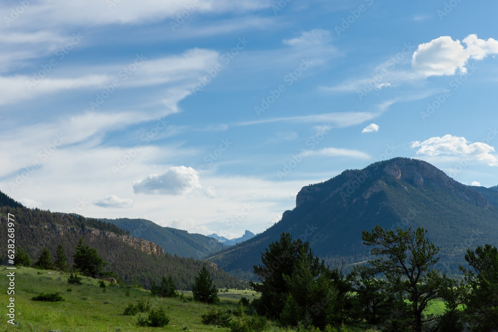 Fototapeta premium Beautiful mountain and hillside landscape scene on scenic drive in Wyoming near Montana in late afternoon golden light on Western USA vacation road trip