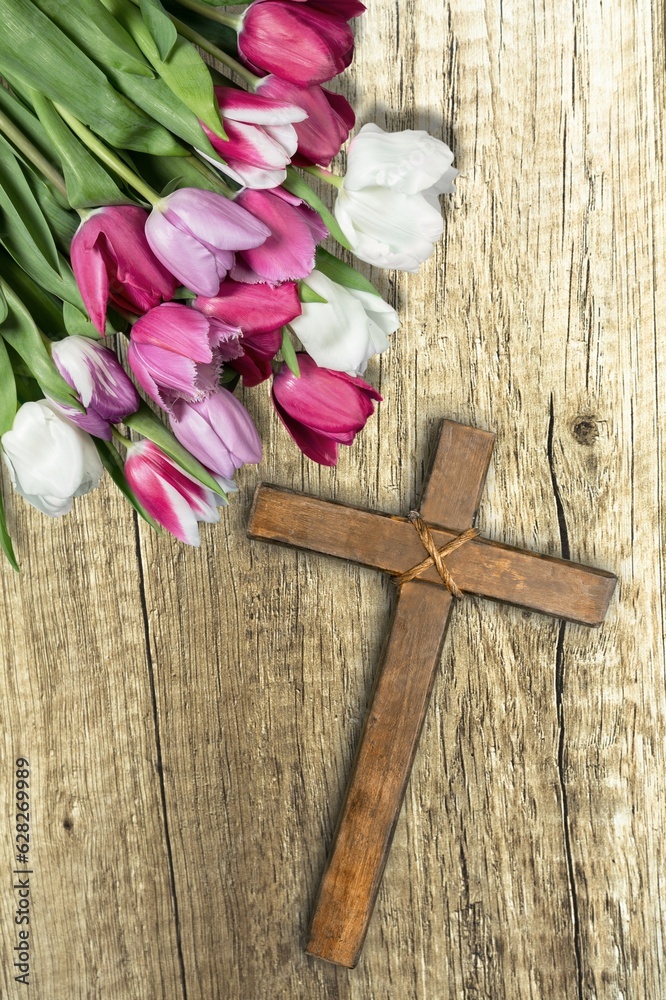 Christian wooden cross with fresh flower branches blossoms Christian wooden cross with fresh flower branches blossoms
