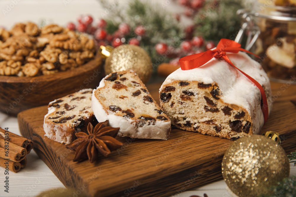 Christmas stollen on wooden background. Traditional Christmas festive pastry dessert. Holiday concept. Dessert, cake, pie with marzipan, nuts and dried fruits. Stollen for Christmas. Spicy pastries. Christmas stollen on wooden background. Traditional Christmas festive pastry dessert. Holiday concept. Dessert, cake, pie with marzipan, nuts and dried fruits. Stollen for Christmas. Spicy pastries.