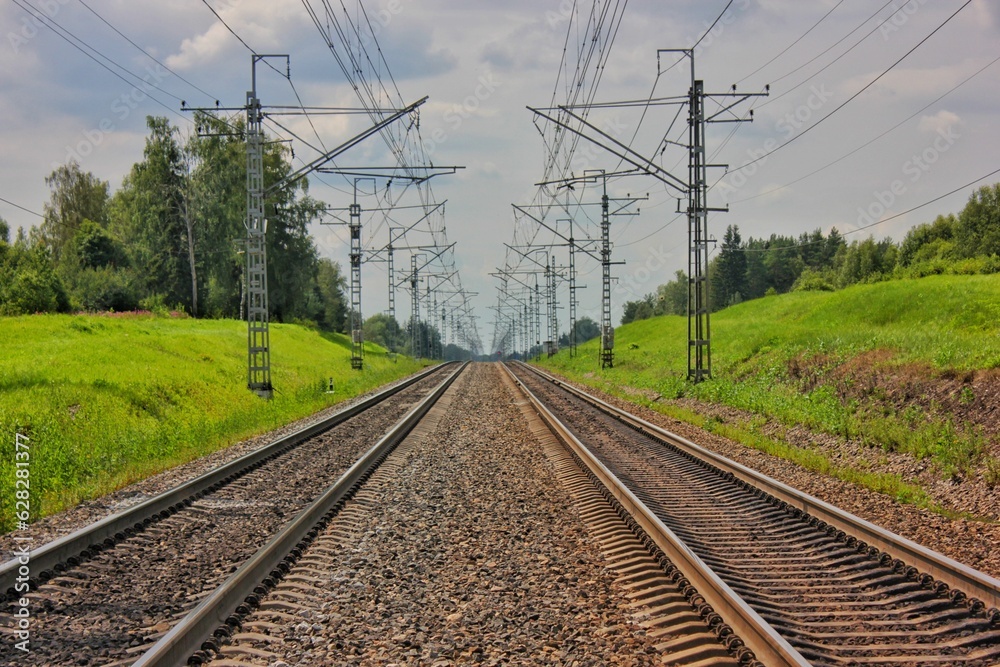 The railway goes into the distance on a summer day The railway goes into the distance on a summer day