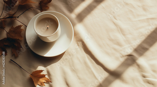 Lit White Candle on Cream Linen Blanket with Dried Fall and Autumn Leaves - Overhead FlatLay View in Muted and Calm Cozy Color Tones - Cottagecore Aesthetic - Generative AI photo