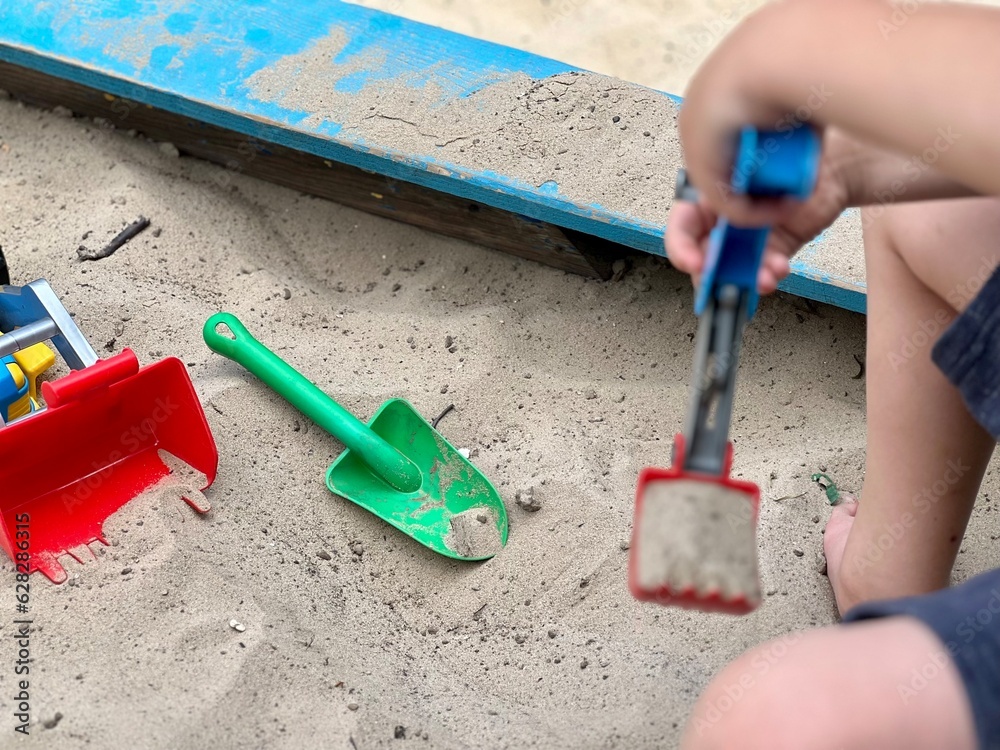Children's wooden sandbox with various toys for the game. Summer concept. Children's wooden sandbox with various toys for the game. Summer concept.