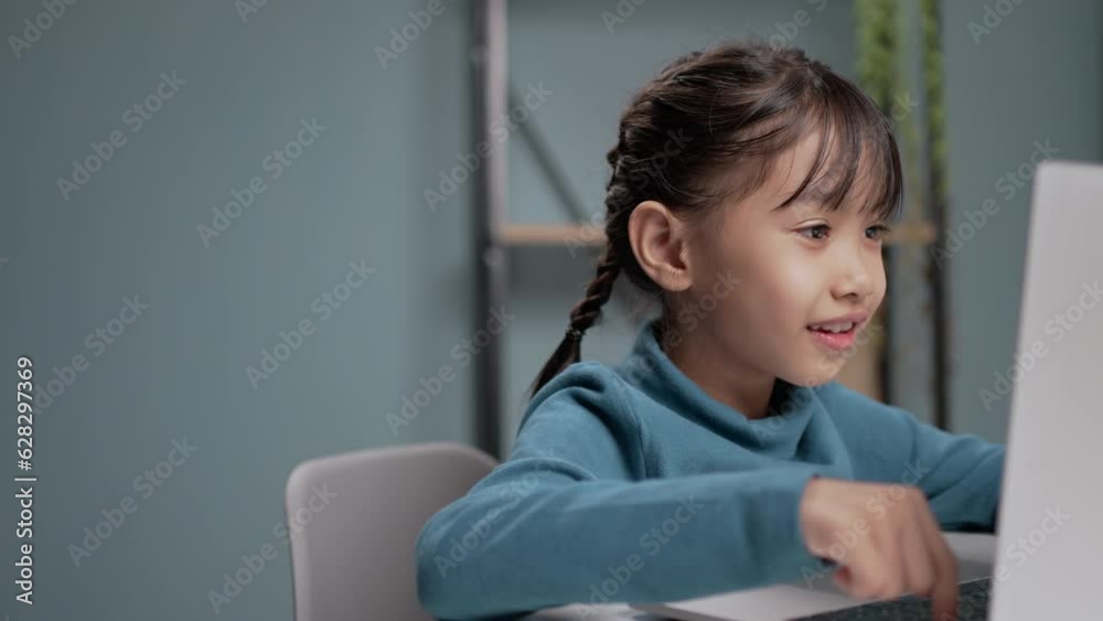 Little girl using a computer laptop for online education. Little girl using a computer laptop for online education.