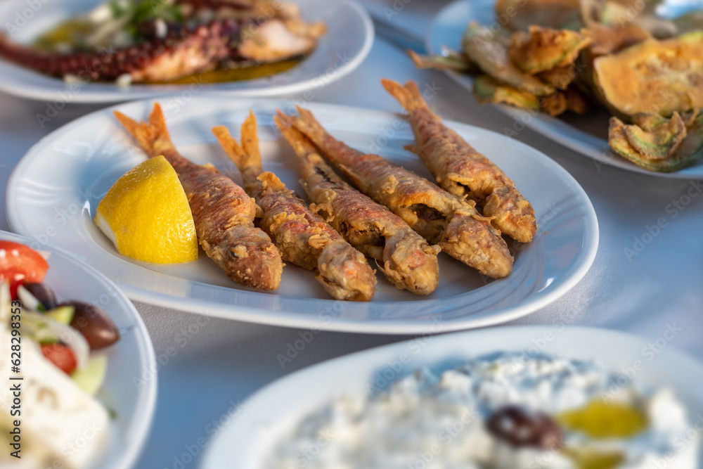 fried red mullet fish plate on table