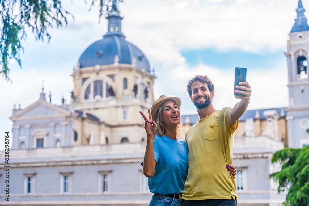 Tourist couple visiting Madrid city on summer vacation. Traveler vacation concept, taking a selfie