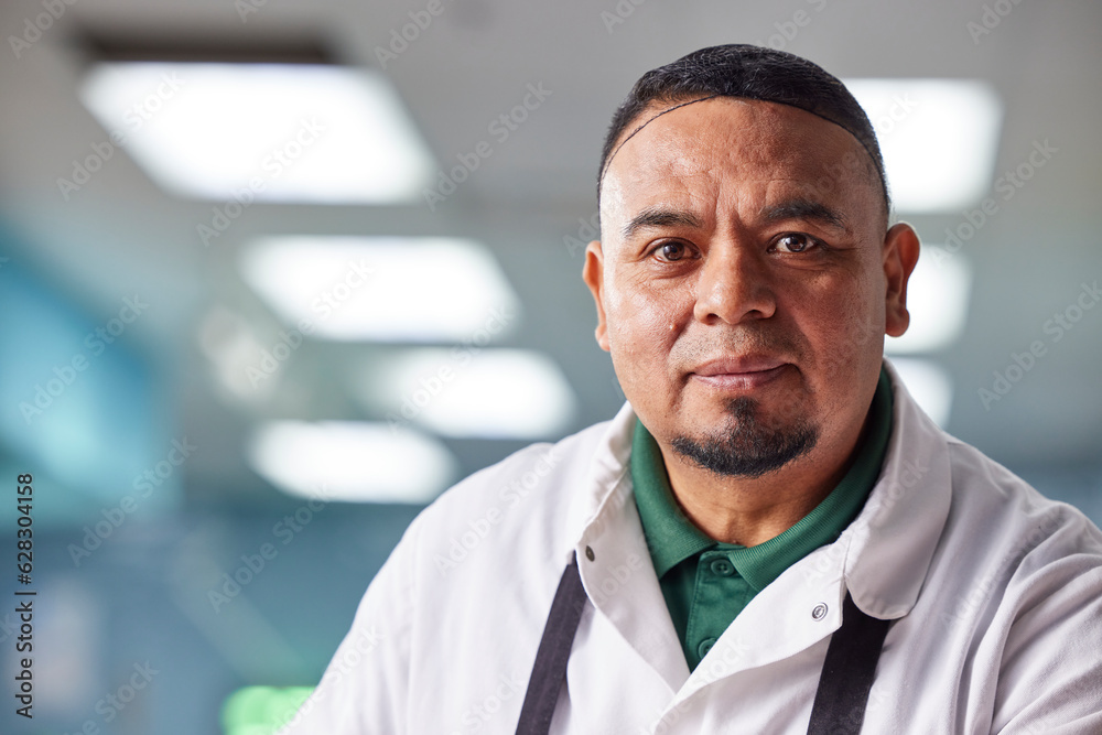Close up, head and shoulder Portrait of butcher wearing hair net in meat market of grocery store Close up, head and shoulder Portrait of butcher wearing hair net in meat market of grocery store