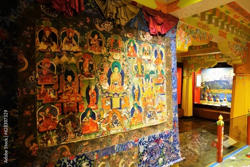 Explore Tibetan spirituality with a captivating Thangka adorned with vibrant Buddhist deities, exhibited at the Himalayan Tibet Museum in Darjeeling, West Bengal.