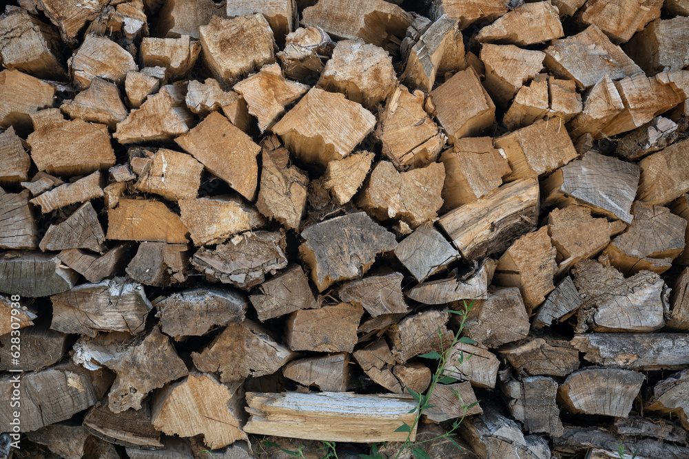 Side view of chopped firewood stacked. Side view of chopped firewood stacked.