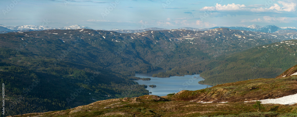Panorama over Andfiskvattnet from the peak of Hauknestinden, Mo I Rana. Hiking up the peak of hauknes viewing the surrounding lakes, mountain peaks. Summer touring in Norway. Mountain lake with island