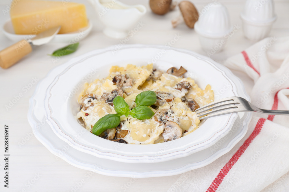 Delicious ravioli with mushrooms and cheese served on white wooden table Delicious ravioli with mushrooms and cheese served on white wooden table