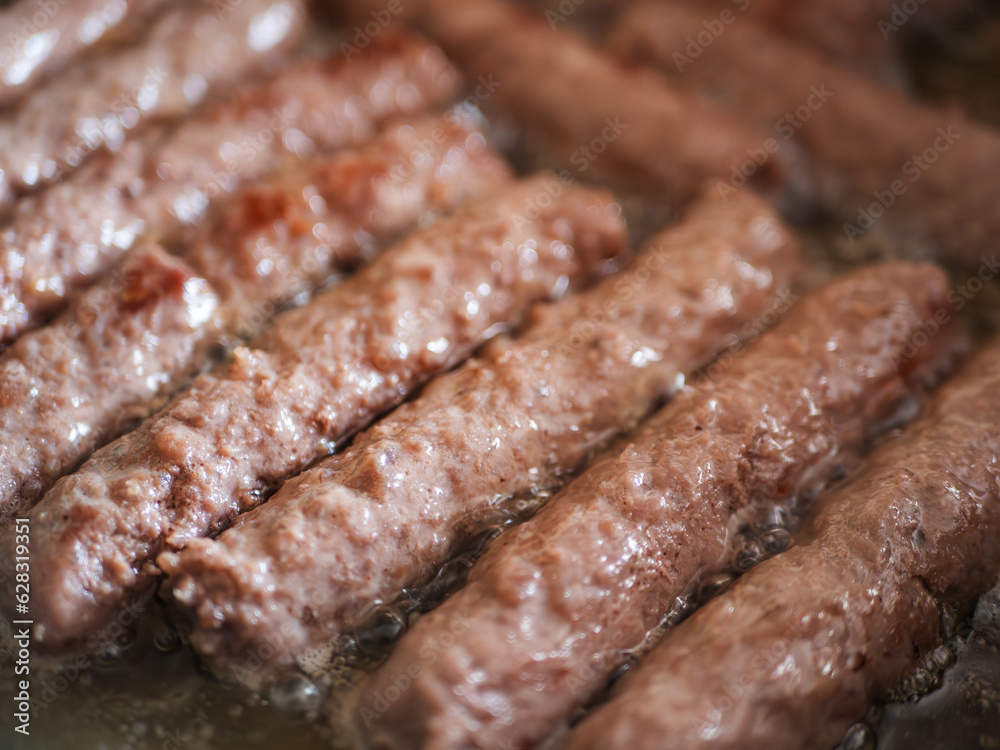 Sizzling Cevapcici - A Delectable Blend of Beef and Pork Pan-Fried to Perfection Sizzling Cevapcici - A Delectable Blend of Beef and Pork Pan-Fried to Perfection
