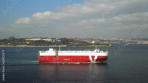 Ro-Ro ship sails past the Old Istanbul City. Aerial. Pure car and truck carrier underway in Bosphorus Sea. Vehicles carrier in front of the Sarayburnu Coast
 photo