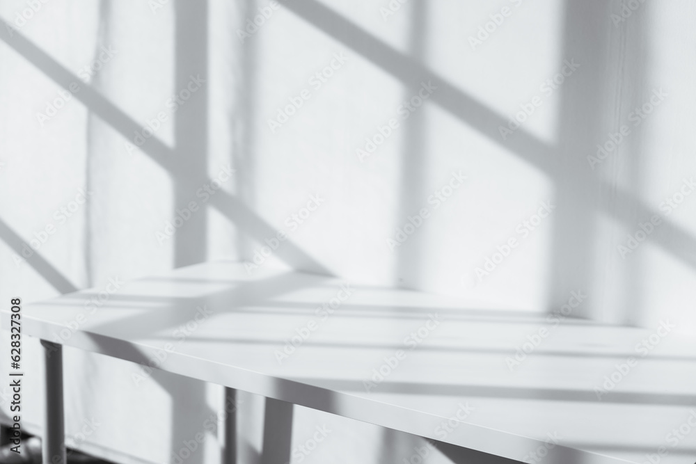Empty tabletop with window shadow on concrete wall texture background, suitable for product presentation backdrop. Empty tabletop with window shadow on concrete wall texture background, suitable for product presentation backdrop.