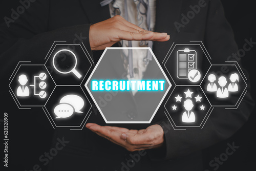 Recruitment concept. Businessman hand holding recruitment icon on virtual screen. photo