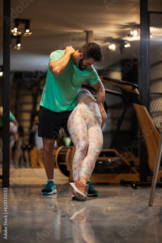Couple in love dancing bachata and tango. Boy and girl having fun during exercise break in a fitness studio.