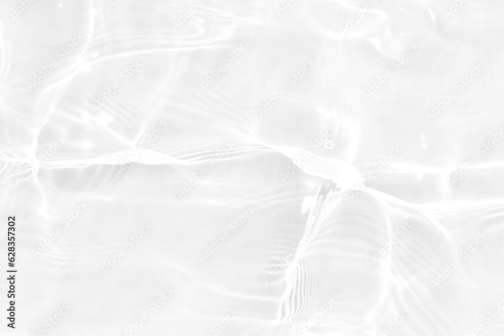 Obraz premium White water with ripples on the surface. Defocus blurred transparent white colored clear calm water surface texture with splashes and bubbles. Water waves with shining pattern texture background.