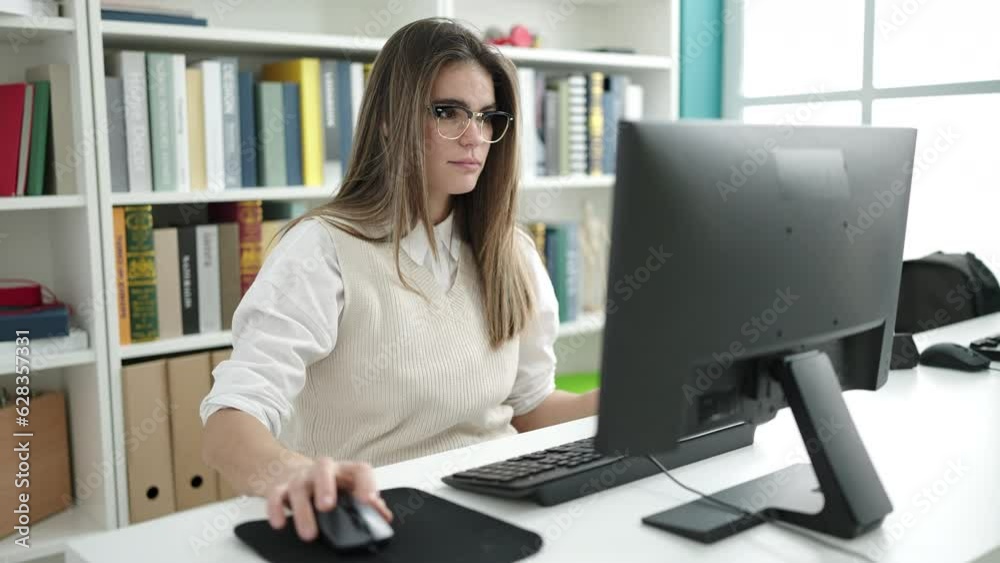 Young beautiful hispanic woman student using computer studying at the library Young beautiful hispanic woman student using computer studying at the library