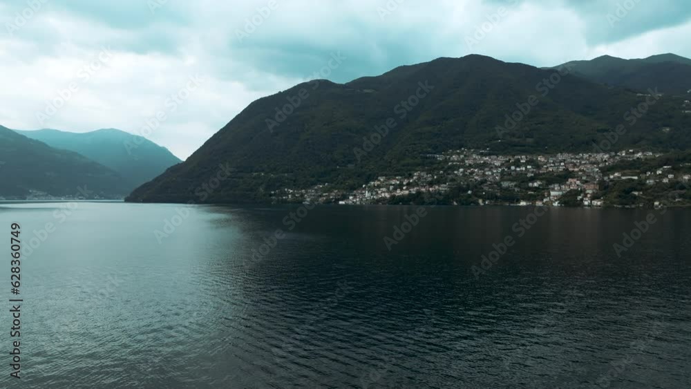 Panoramic drone view of village along coast of Como Lake in Italy