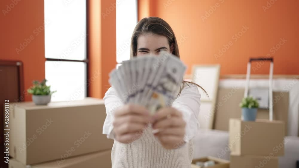 Young beautiful hispanic woman smiling confident holding money at new home Young beautiful hispanic woman smiling confident holding money at new home