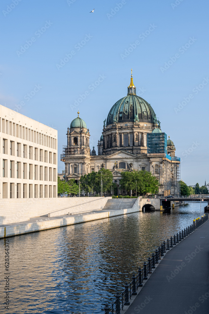 The backside of rebuilt City Palace with the Berliner Dom and the river Spree on a sunny day