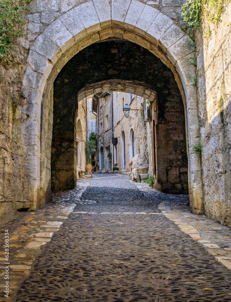 Arched passage way in the traditional medieval stone city walls of the Old Town, Vieille Ville in Saint Paul de Vence, French Riviera, South of France