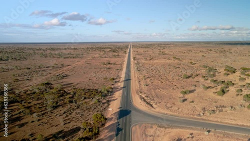 Aerial view above 90 miles straight road, australia on a sunny, desert outback, tilt , drone shot photo