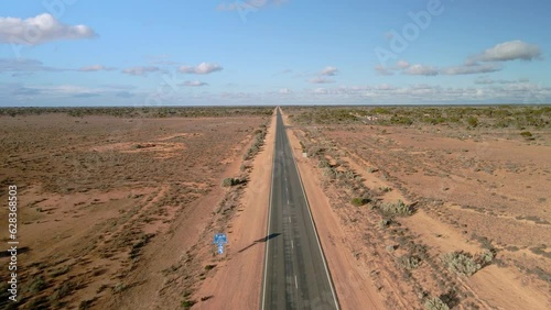 Aerial view above 90 miles straight road, australia on a sunny, desert outback, drone shot photo