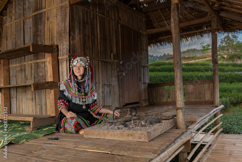 Hill tribe Asian woman in traditional clothes collecting tea leaves with basket in tea plantations terrace, Chiang mai, Thailand collect tea leaves