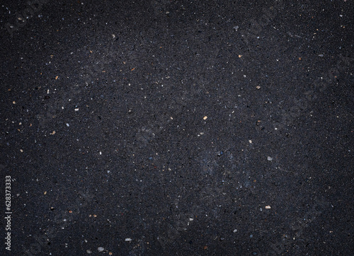 Background texture of asphalt with fine grain and light spots on it