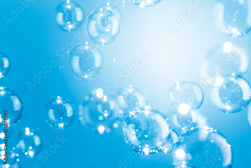 Beautiful Transparent Shiny Blue Soap Bubbles Floating in The Air. Abstract Background  Celebration Festive Backdrop  Refreshing of Soap Suds  Bubbles Water. 