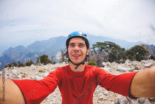 man climber makes selfie photography with mountains. climbing and mountaineering