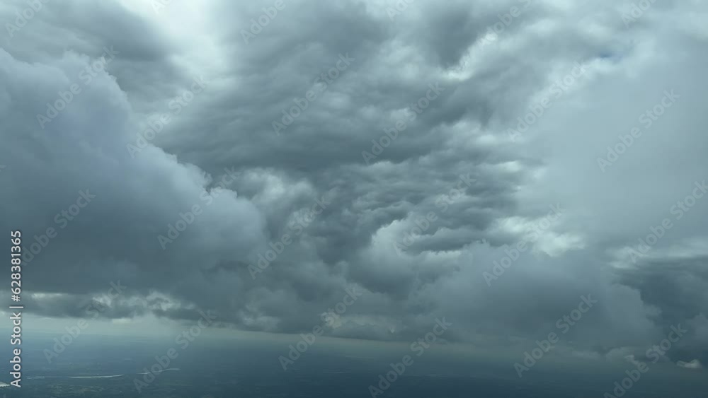 Awesome view from a jet cain while flying near the botton of a huge storm cloud in a left turn to avoid. 5000m high. A pilot’s POV Awesome view from a jet cain while flying near the botton of a huge storm cloud in a left turn to avoid. 5000m high. A pilot’s POV