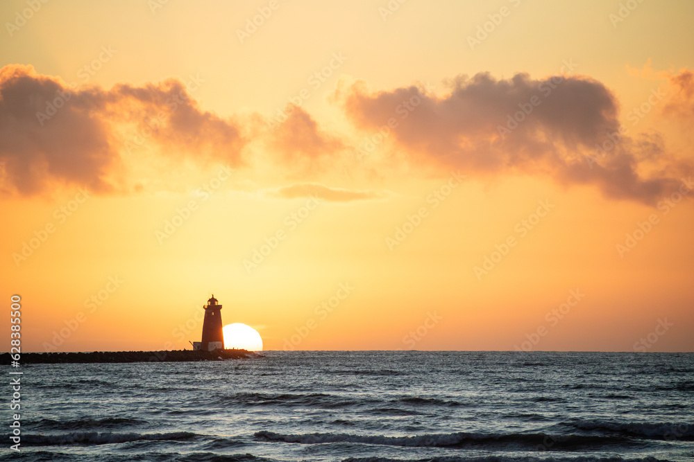 Sun rising behind a lighthouse, beautiful sunrise Sun rising behind a lighthouse, beautiful sunrise