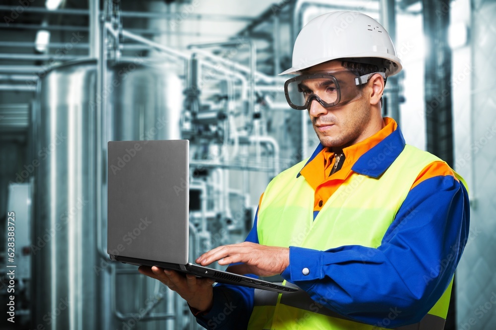 Heating plant with pipes interior and factory worker Heating plant with pipes interior and factory worker